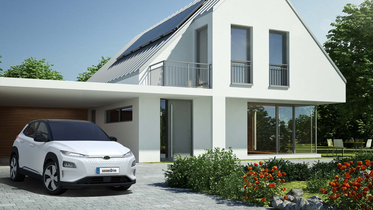 Elektroauto Hyundai Kona steht vor einem modernen Haus mit Garten