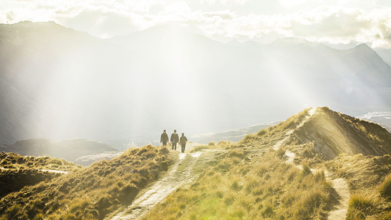 People walking on a mountain in the sunshine