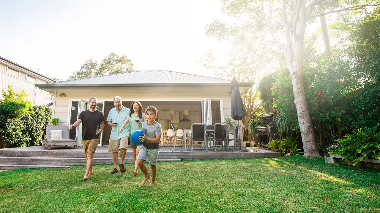 A family in the garden running on the gras