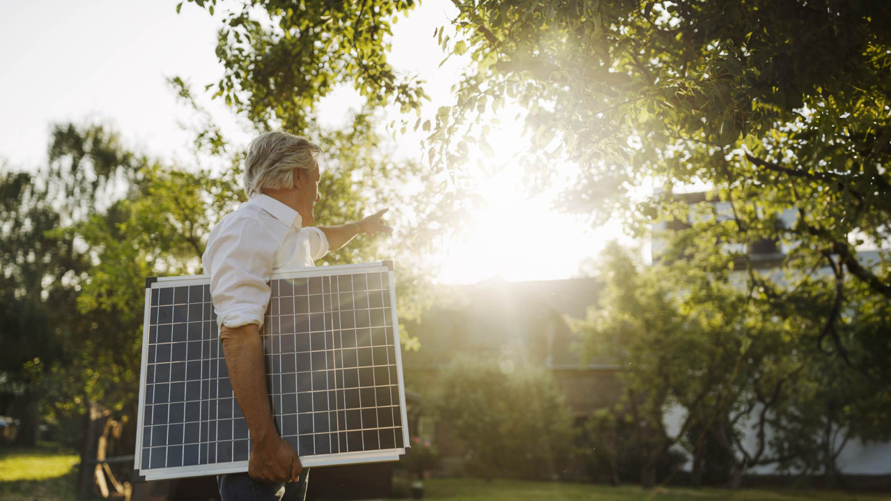 Man holding solar panel